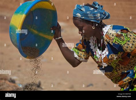 A Fulani Woman In The Town Of Djibo In Northern Burkina Faso Uses Wind