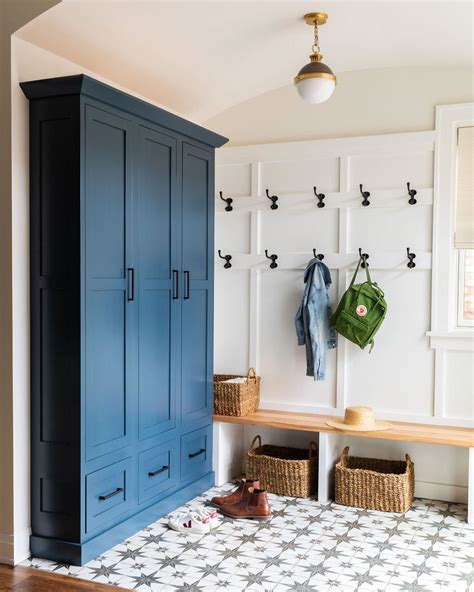 Custom Mudroom Cabinetry And Wall Paneling With Geometric Floor Tile