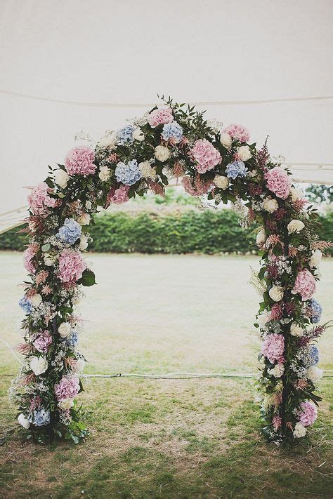 A Pastel Spring Wedding Arch Of Foliage Pink And Blue Hydrangeas For A