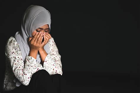 Young Muslim Girl Sitting In Dark Room Feeling Pain With Life Problem