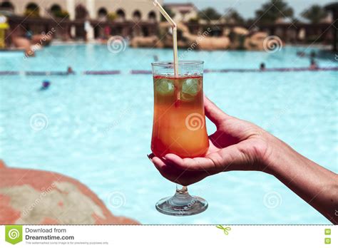 A Delicious Alcoholic Cocktail Sex On The Beach In A Female Hand On The Background Of The Pool