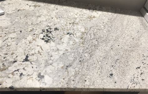 A Kitchen Counter Top With White And Black Speckles