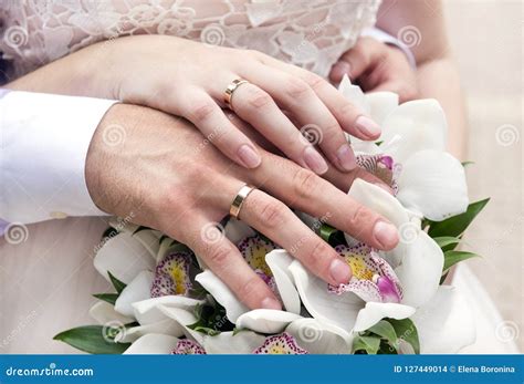 Hands Of The Bride And Groom With Wedding Rings On The Wedding B Stock