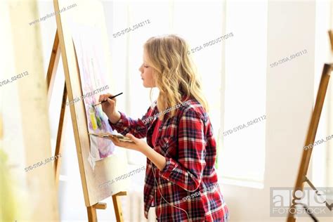 Student Girl With Easel Painting At Art School Stock Photo Picture