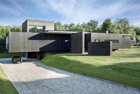 Black Modern House Consisting Of Five Modules Clustered Around A