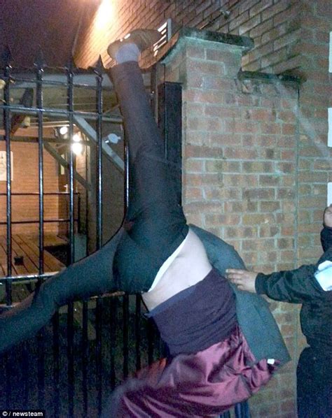 pic drunk man hangs upside down after impaling leg climbing over a gate to get into a pub the