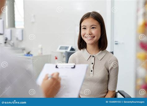 smiling teenage girl in doctors office stock image image of doctor holding 154409155