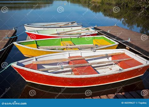Floating Color Wooden Boats With Paddles In A Lake Stock Image Image