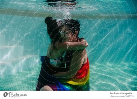 Two Women At The Pool Together Wrapped With Rainbow Gay Flag Lgbt Concept A Royalty Free