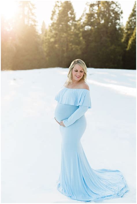 Expecting Mother Posing In The Snow For Winter Maternity Pink Blush Maternity Dresses