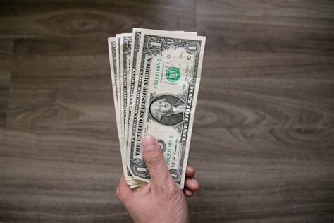 Free Stock Photo of One Us Dollar Bills In Left Hand