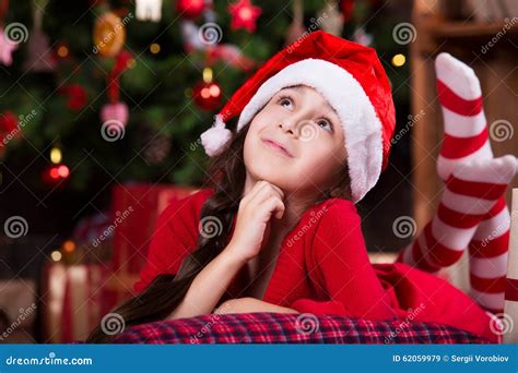 Cute Little Girl In Santa Hat Dreaming Near The Stock Image Image Of