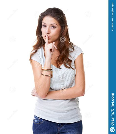 Keep It Down Portrait Of A Pretty Young Woman With Her Finger To Her Lips Stock Image Image