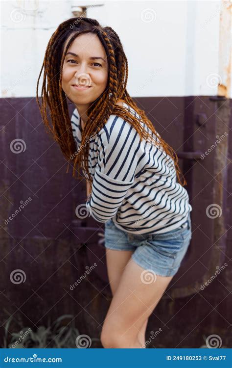 A Girl With A Dreadlocked Hairstyle Poses In The Summer Outdoors