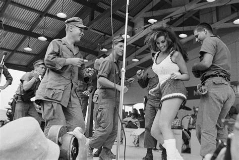 Raquel Welch Dances On Stage With A Group Of Soldiers During A Bob Hope