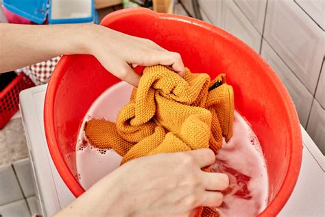 Hand Pours Liquid Detergent Into The Washing Machine Creative Commons