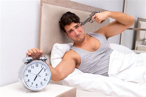 The Young Man Having Trouble Waking Up In The Morning Stock Photo