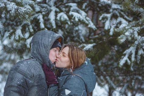 Happy Snow Covered Couple Kissing Under Fir Branches In Winter Forest Concept Healthy Romantic