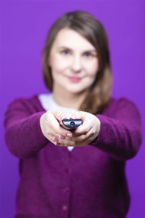 One Caucasian Woman In Purple Pullover Clothing Holding And Pointing Tv