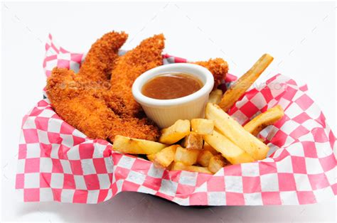 Breaded Chicken Strips With French Fries And Dipping Sauce In A Stock