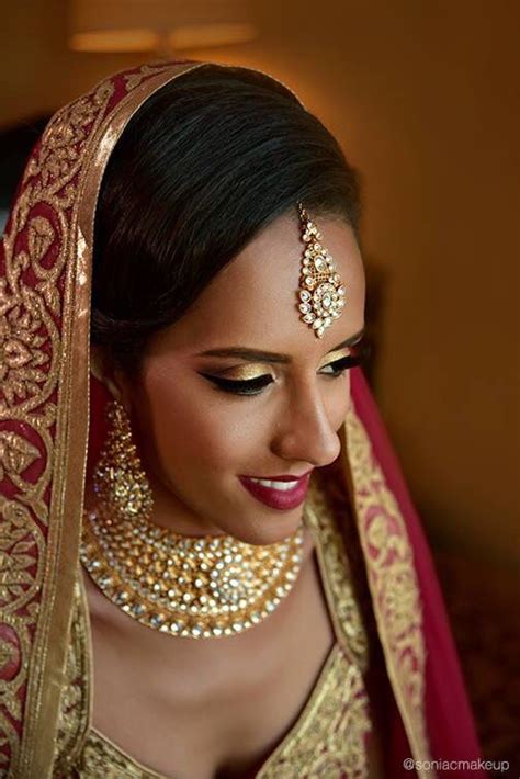 Makeup For Deep Skin Punjabi Bridal Look Gold Smokey Eyes And Red Lips With Bronzed Skin And