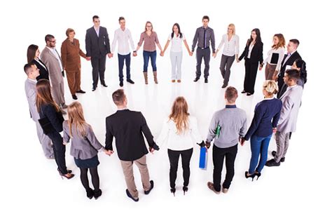 Large Group Of Business People Holding Hands In A Circle Stock Photo
