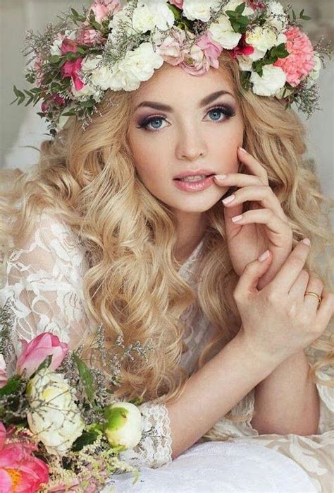 A Woman With Long Blonde Hair And Flowers In Her Hair Is Posing For The