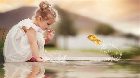 Cute Little Girl Is Playing On Water Wearing White Dress