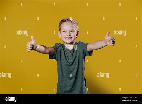 Portrait Of A Confident Smiling Ten Year Old Boy Standing In Front Of