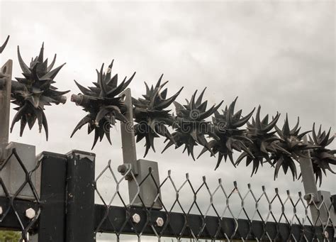 Close Up Of Metal Spikes On Fence Protecting Power Grid Stock Photo