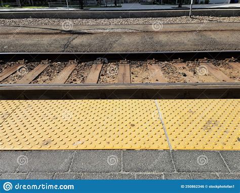 Yellow Tactile Bumps On Cement Next To Train Track Stock Photo Image