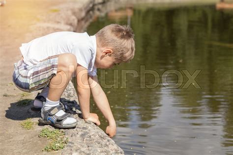 Happy Little Boy Playing With Water At Stock Image Colourbox