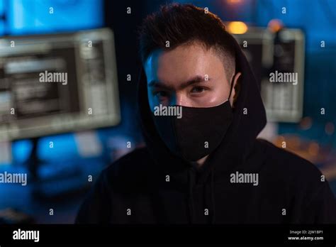 Hacker Wearing Mask With Computers In Dark Room Stock Photo Alamy