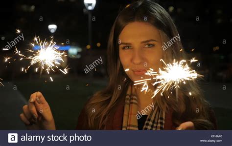 Young Beautiful Happy Smiling Girl Holding Sparkler On The Street
