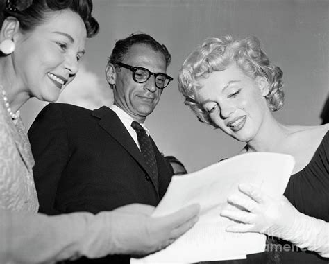 Marilyn Monroe Signing An Autograph Photograph By Bettmann