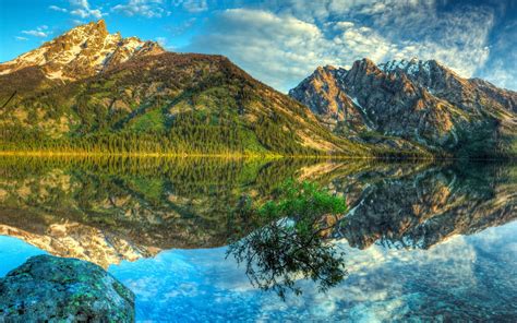 Reflection Of Green Mountain On Calm Body Of Water Under Blue Skies Hd