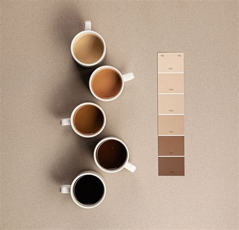 Three Cups Of Coffee Sit Next To Each Other On A Table With The Color