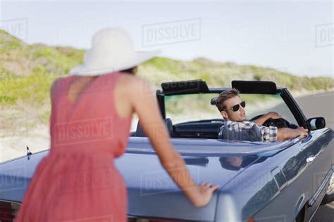 Woman Pushing Car As Boyfriend Steers Stock Photo Dissolve