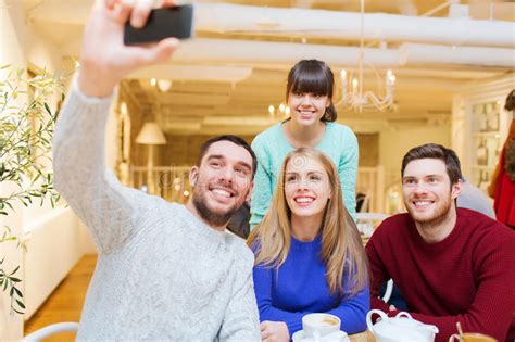 Group Of Smiling Friends With Smartphone Photographing And Taking Selfie Stock Image Image Of