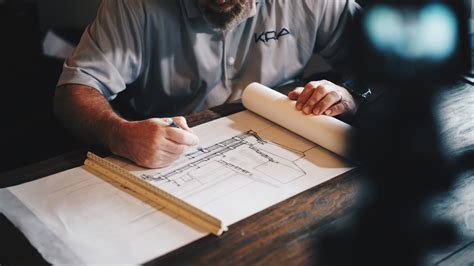 An Architect Working On A Draft With A Pencil And Ruler Architect At