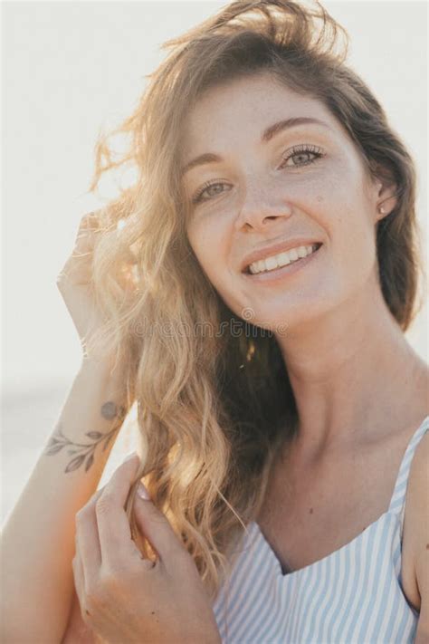 Portrait Of A Woman In A White Dress On The Street Walk Stock Photo