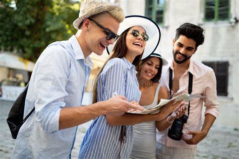 Happy Group Of Tourists Traveling And Sightseeing Together Stock Photo