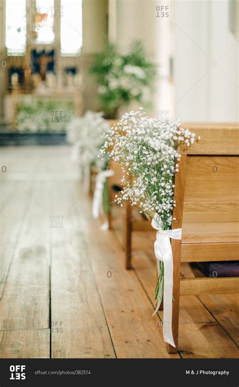 Babys Breath Bouquets Tied To The End Of Wood Church Pews In A Wedding