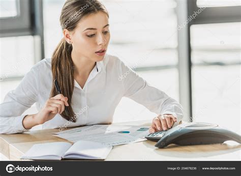 Young Confident Businesswoman Paperwork Using Conference Phone Office
