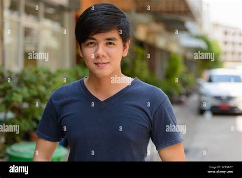 Portrait Of Young Handsome Asian Man Outdoors Stock Photo Alamy