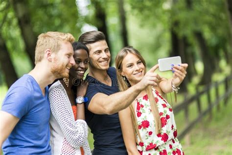 Group Of Young People And Couples Taking Selfies In Nature Stock Image