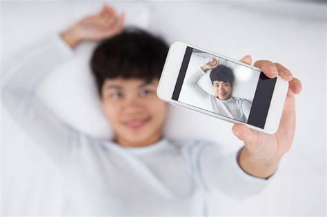 Free Photo Smiling Pretty Asian Woman Taking Selfie In Bed