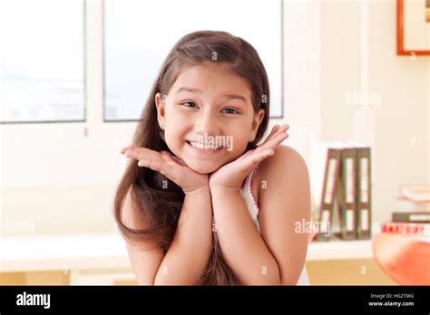 Portrait Of Smiling Girl Resting Chin On Hands Stock Photo Alamy