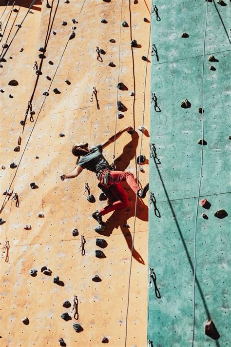 One Caucasian Man Professional Rock Climber Workouts On Climbing Wall