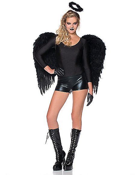 A Woman In A Black Outfit With An Angel Wings